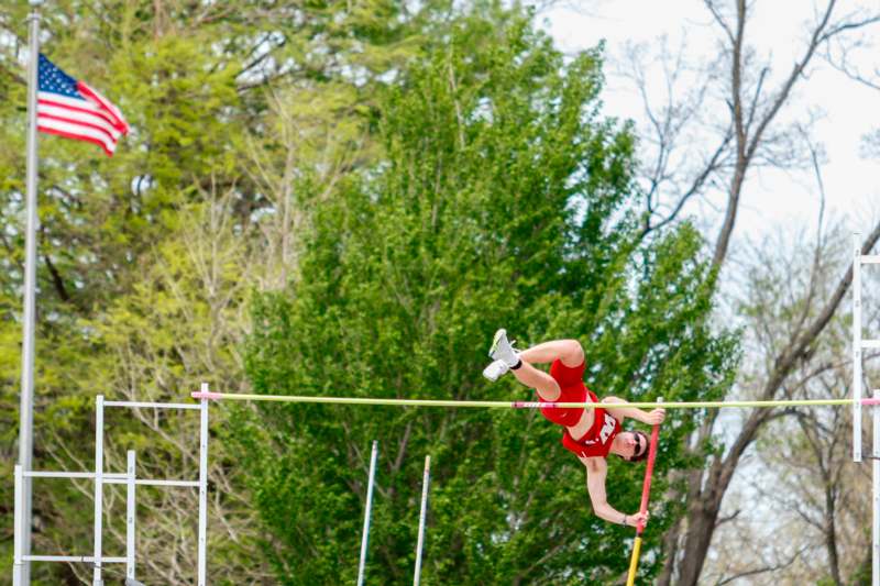 a man jumping over a bar