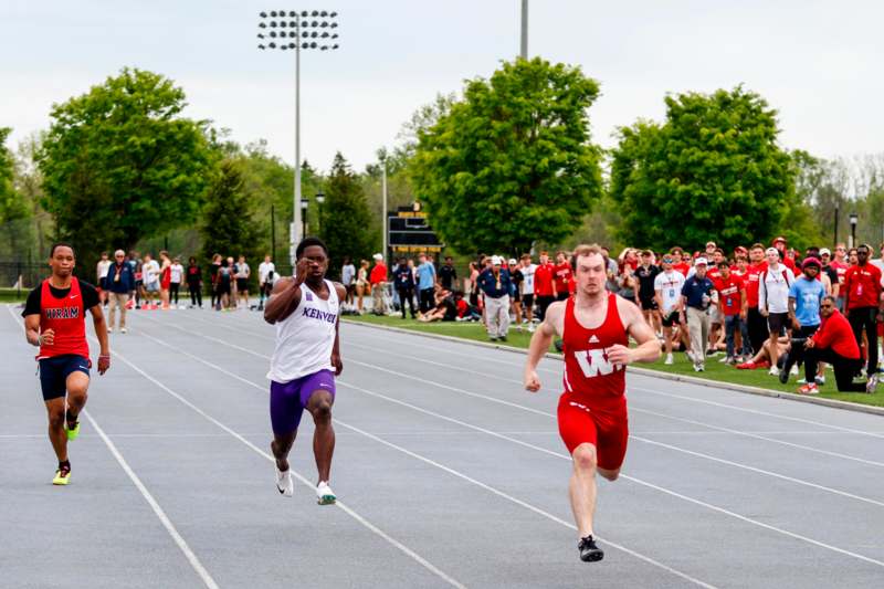 a group of men running on a track