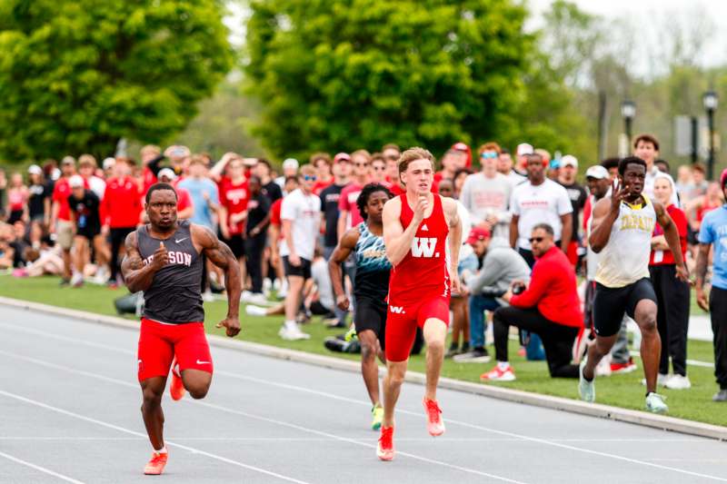 a group of men running on a track