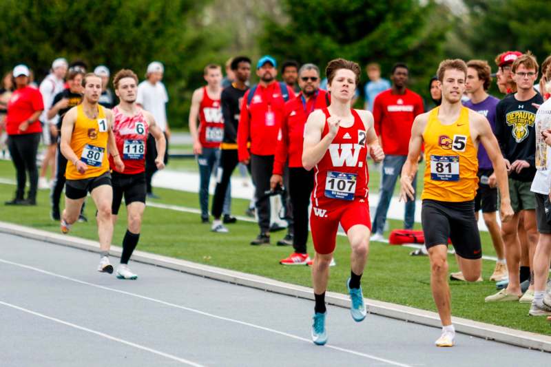 a group of people running on a track