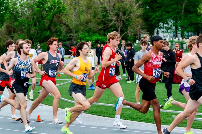 a group of people running on a track