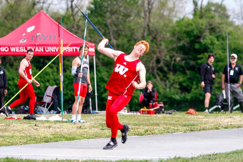 a man in red uniform holding a javelin