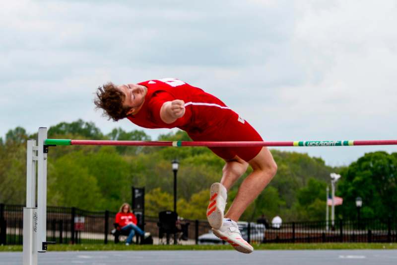 a man jumping over a bar