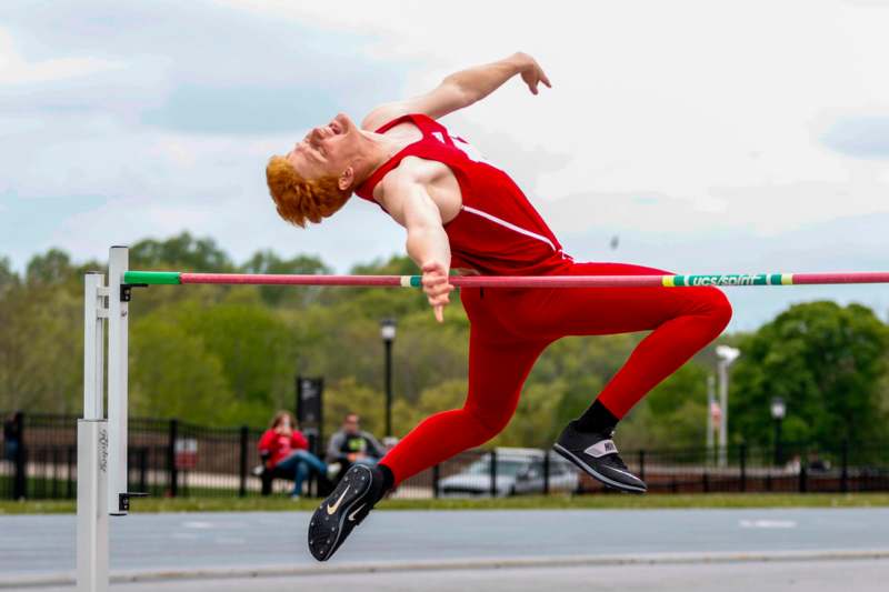 a man jumping over a pole