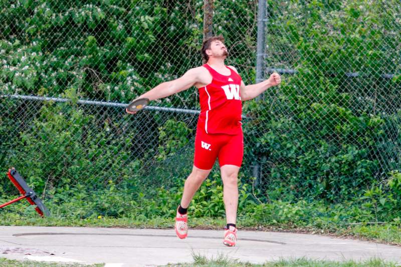 a man in red shorts throwing a frisbee