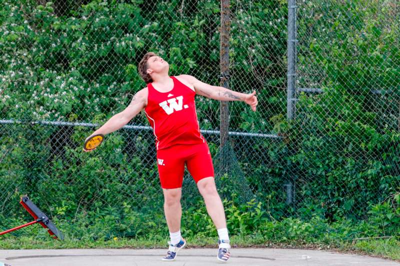 a man in red shorts holding a frisbee