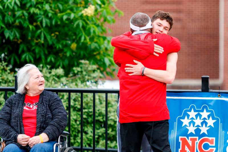a man hugging another man