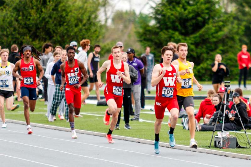 a group of people running on a track
