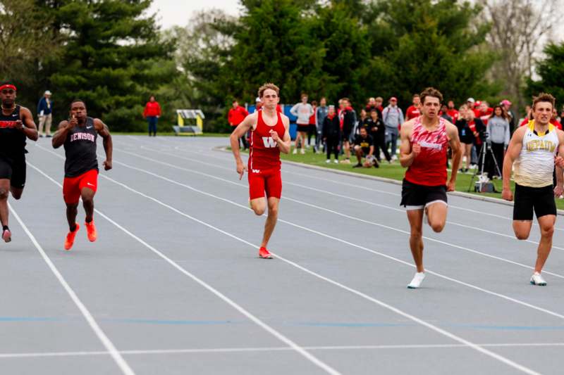 a group of men running on a track