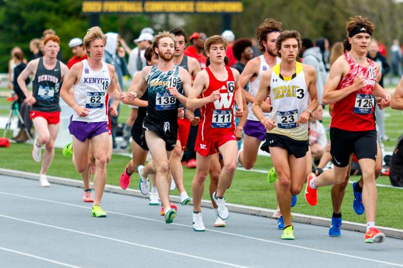 a group of people running on a track