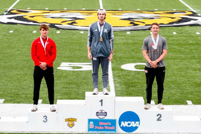 a group of men standing on a podium on a football field