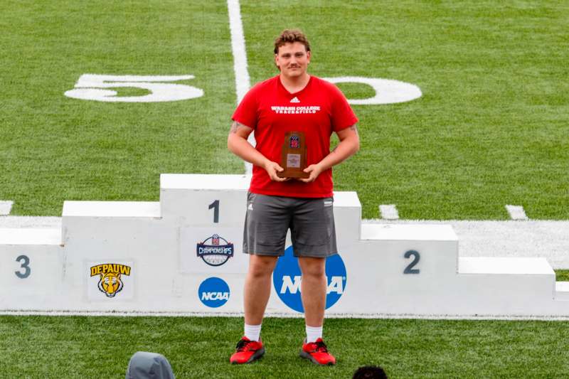 a man holding a trophy