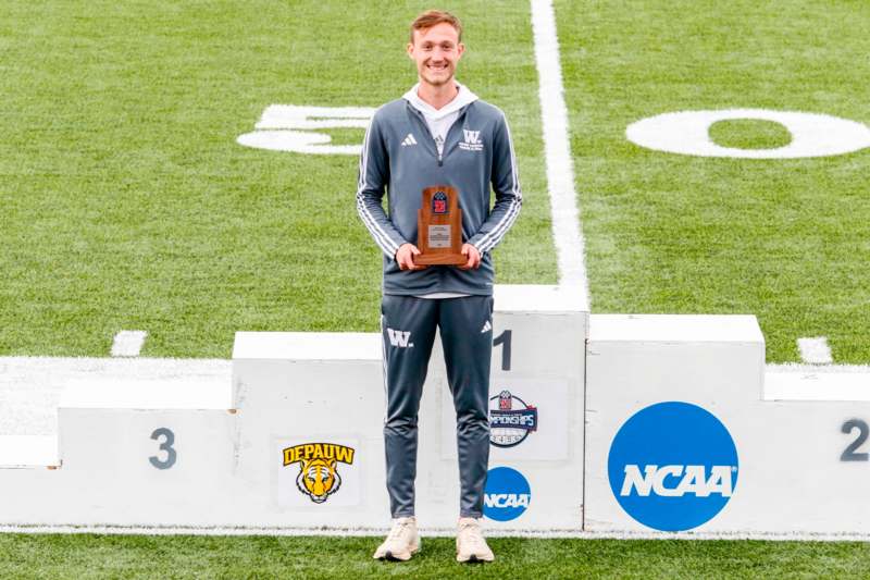 a man holding a trophy