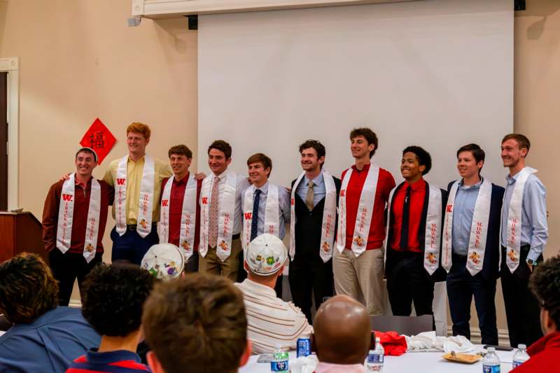 a group of people standing in a row