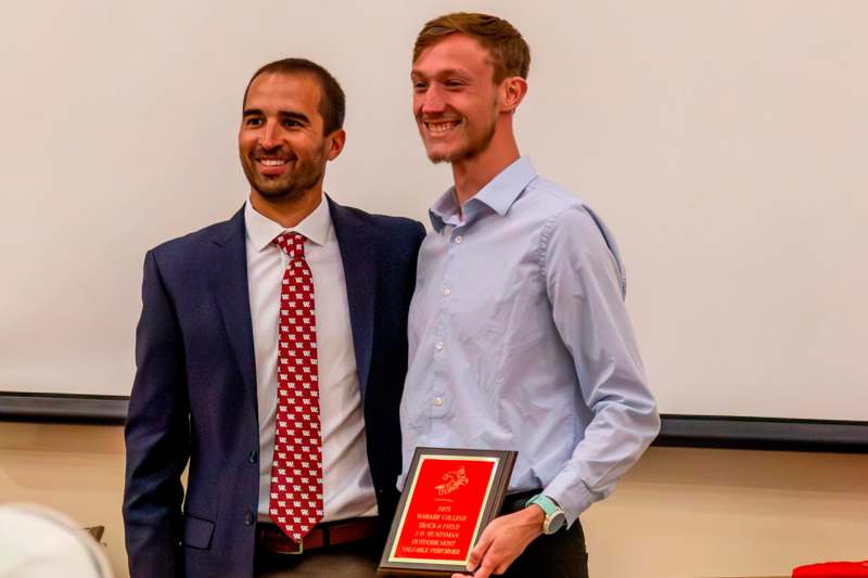 two men smiling at the camera