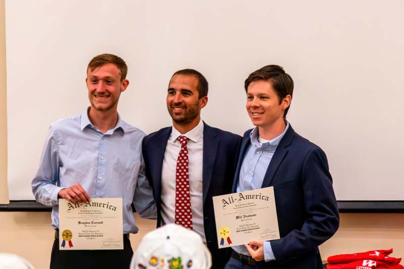 a group of men holding certificates