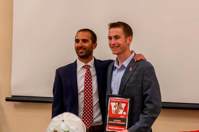 a man holding a plaque with a man in a suit