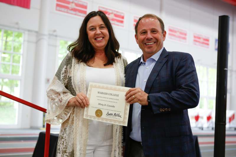 a man and woman holding a certificate