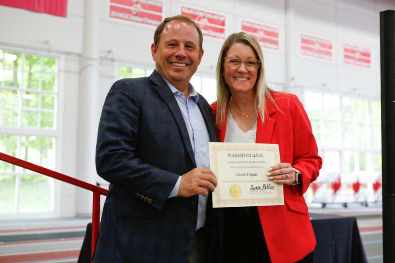 a man and woman holding a certificate