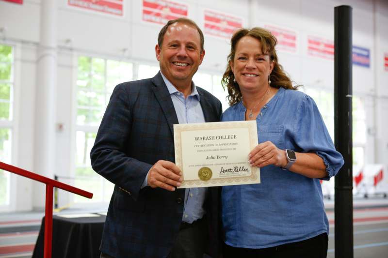 a man and woman holding a certificate