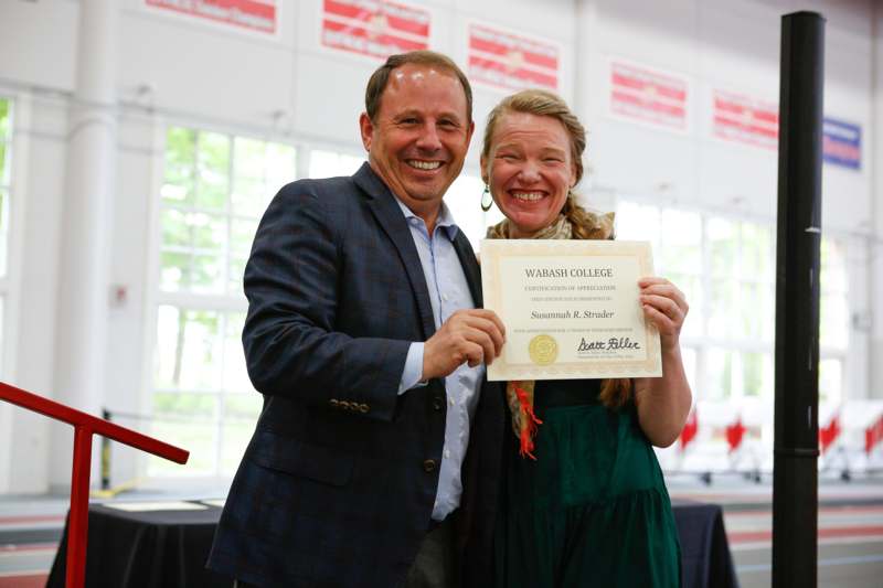 a man and woman holding a certificate