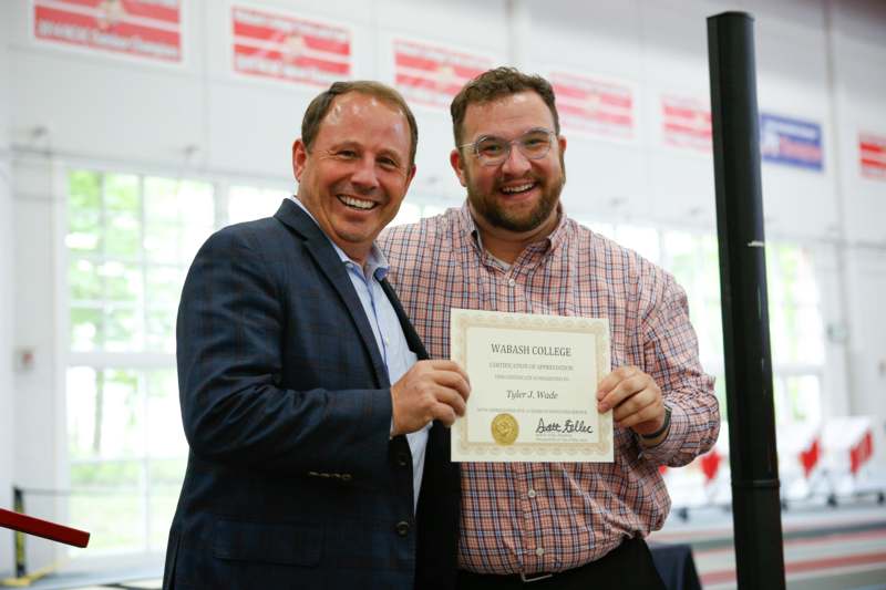 two men holding a certificate