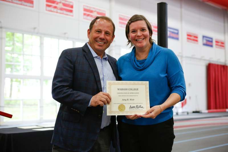 a man and woman holding a certificate
