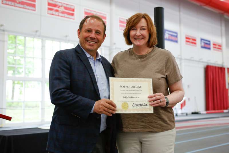 a man and woman holding a certificate