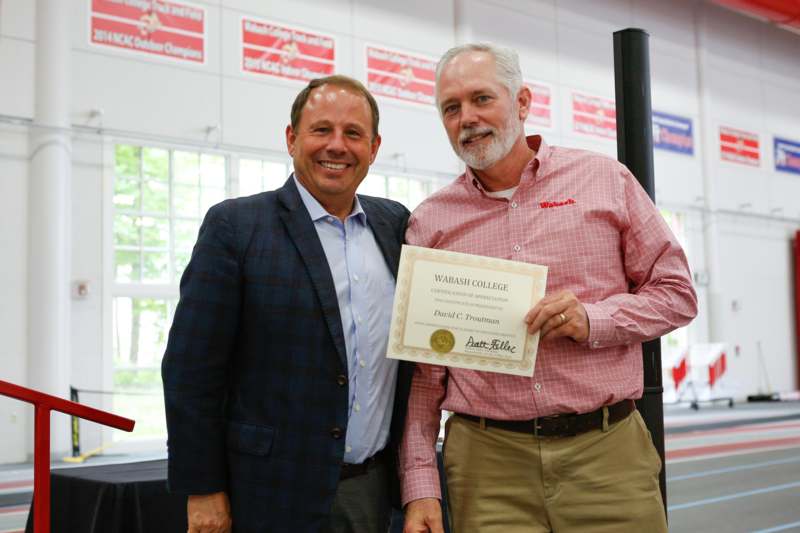 two men holding a certificate