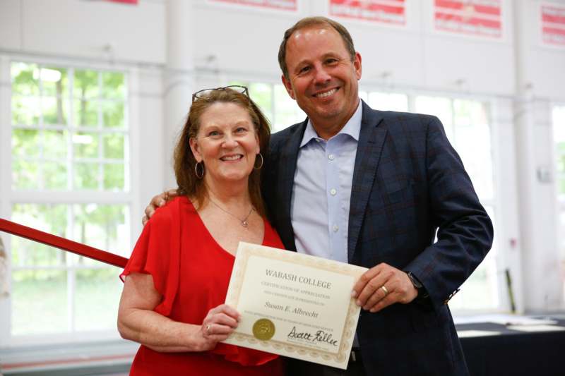 a man and woman holding a certificate