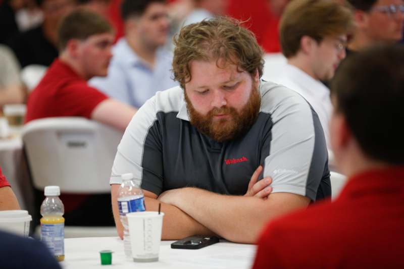 a man sitting at a table with his arms crossed