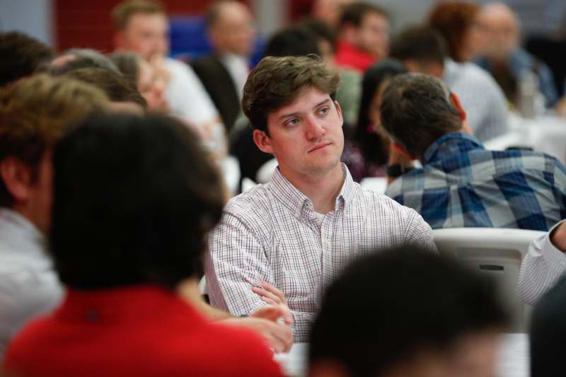 a man sitting in a room with other people