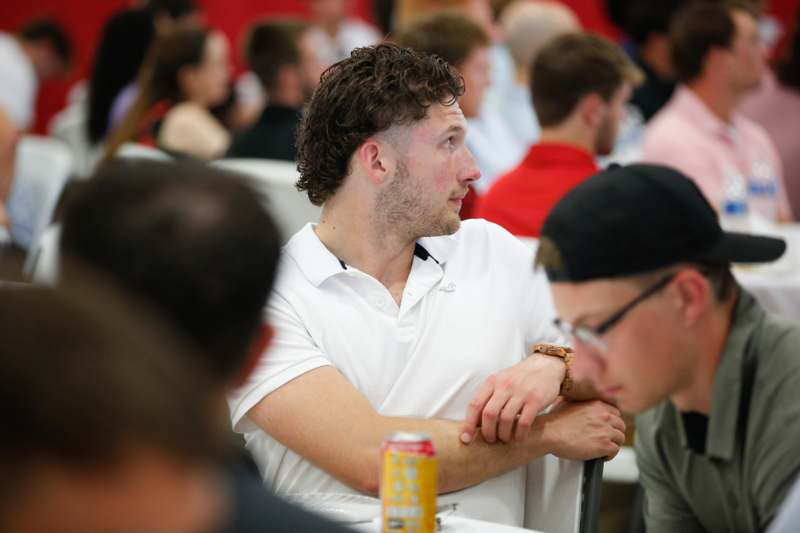 a man sitting at a table with a drink