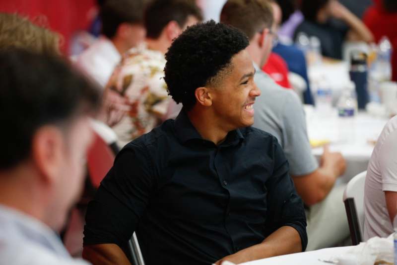 a man smiling at a table