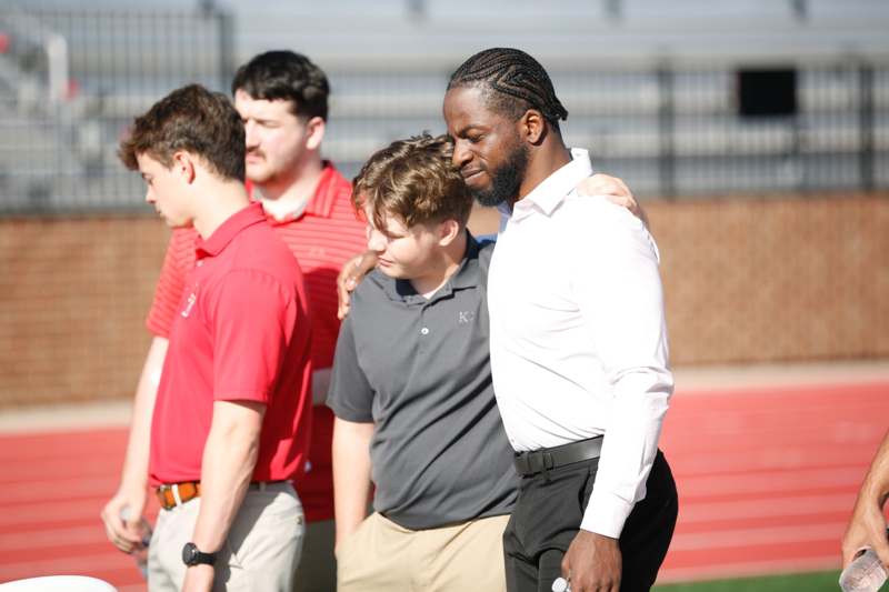 a group of men standing on a field