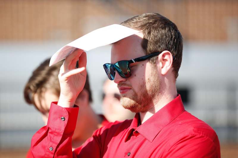 a man holding a piece of paper over his head