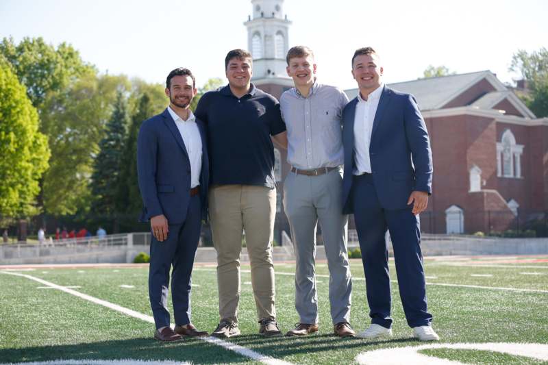 a group of men standing on a football field
