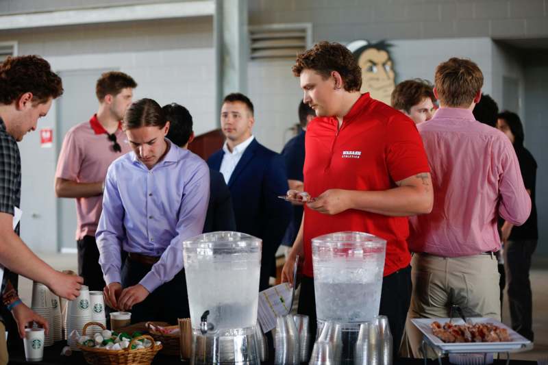 a group of people standing around a table