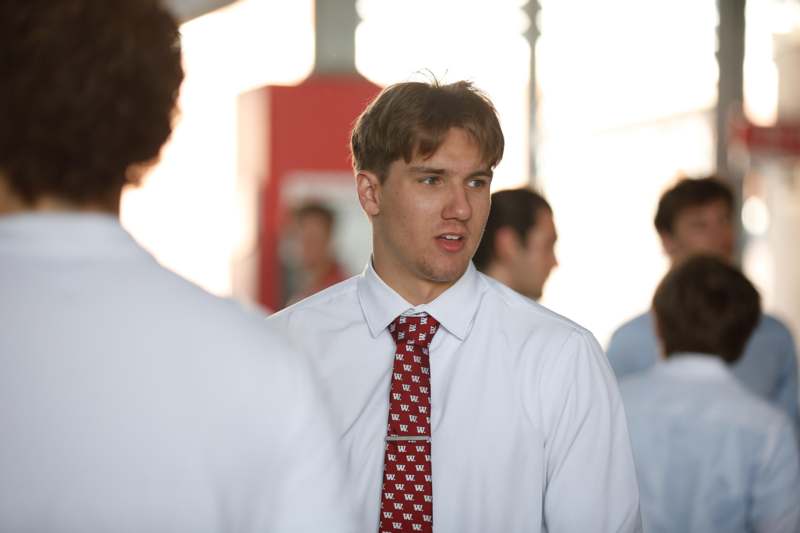 a man in a white shirt and red tie