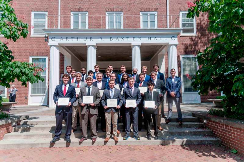 a group of people holding certificates