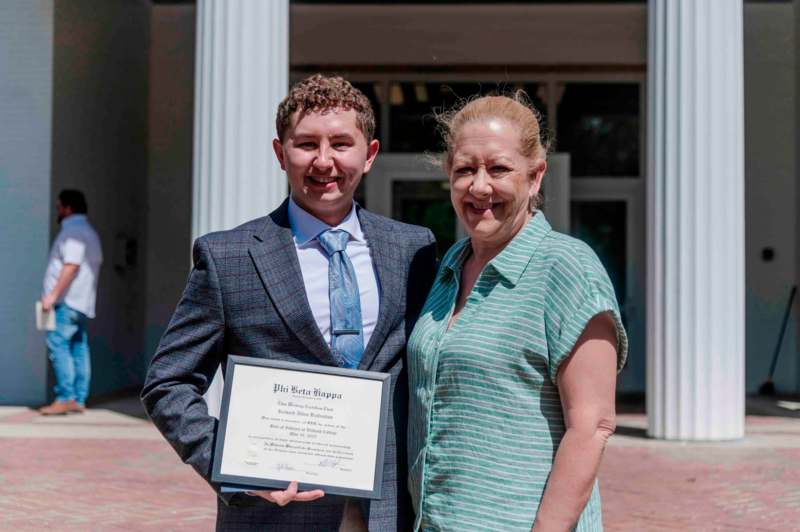a man and woman holding a certificate