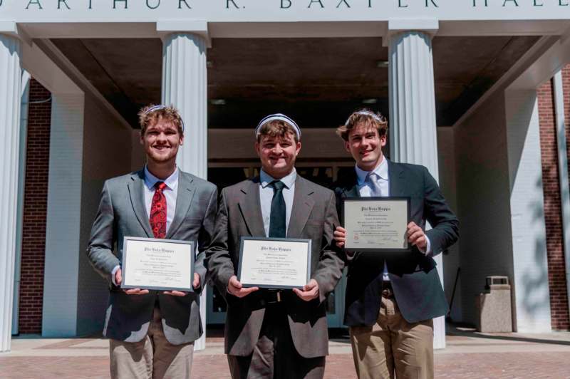 a group of men holding certificates
