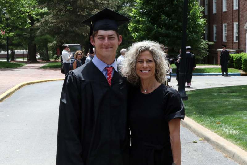 a man and woman in graduation gowns