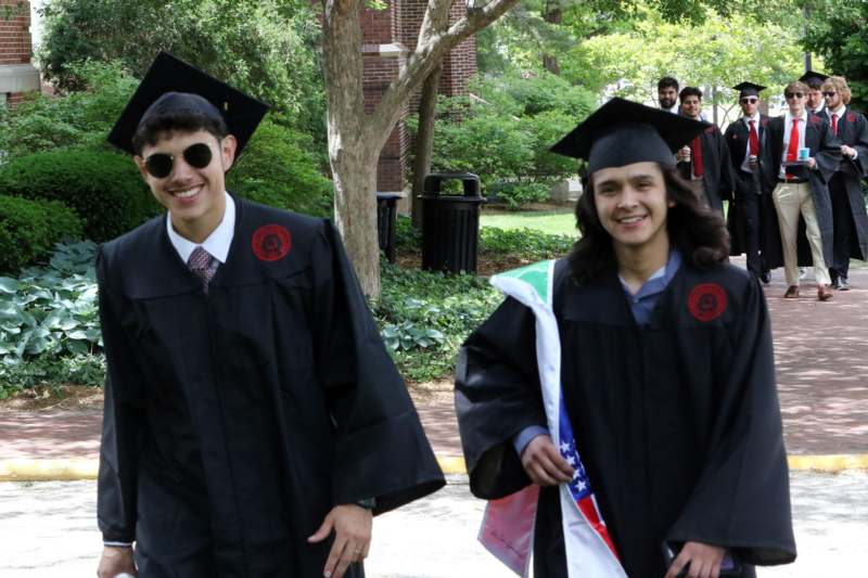 a group of people in graduation gowns and caps