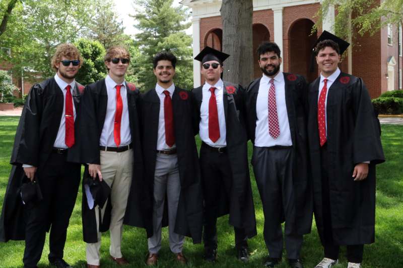 a group of men wearing graduation gowns and caps