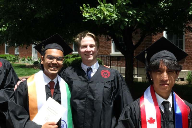 a group of men in graduation gowns and caps