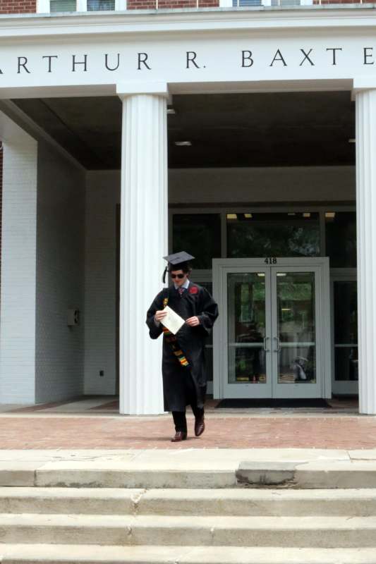 a man in a graduation gown and cap