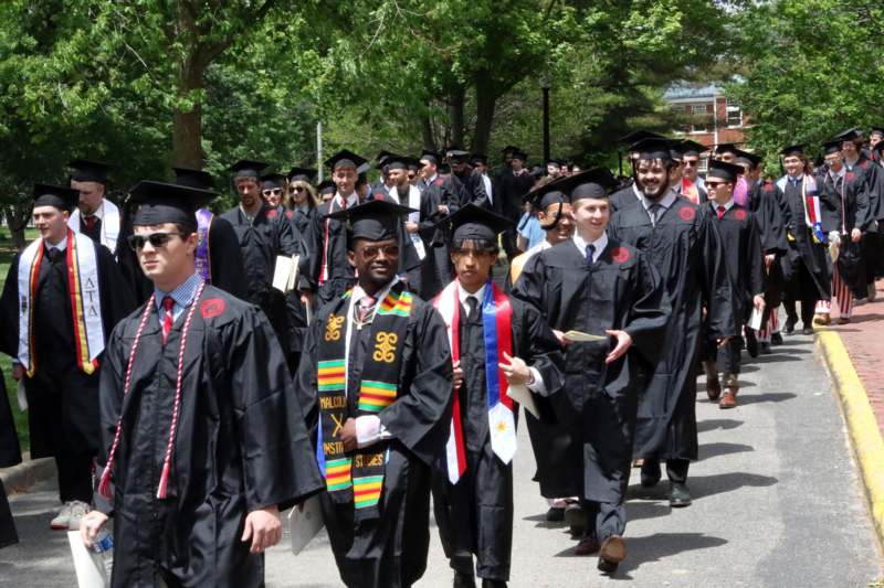 a group of people in graduation gowns and caps