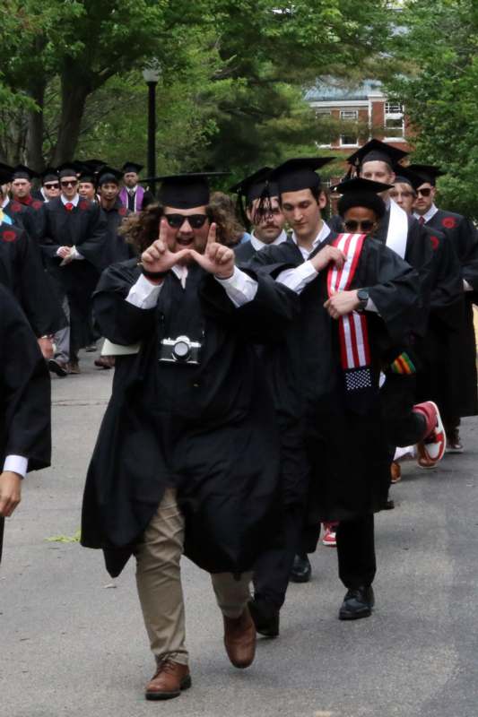 a group of people in graduation gowns and caps