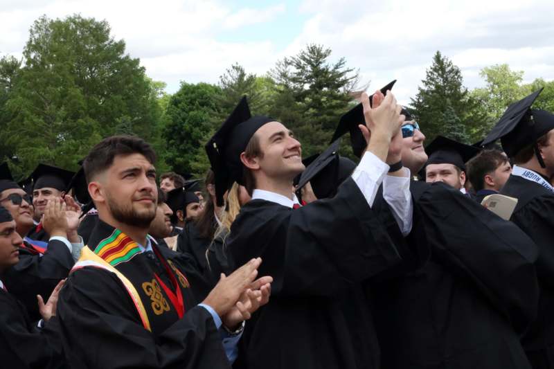 a group of people in graduation gowns and caps